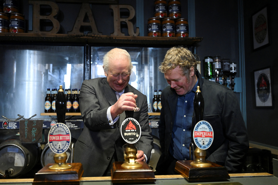 The King pulls a pint after a day out in Staffordshire